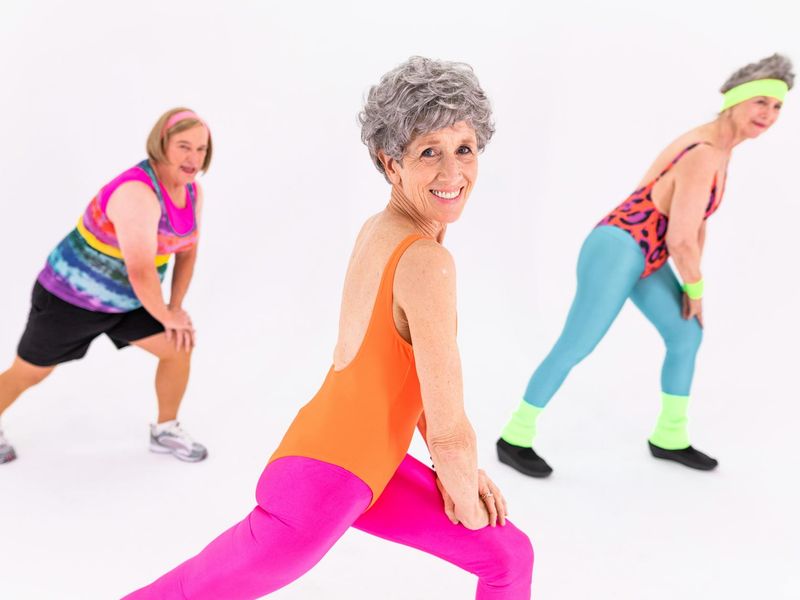 Person moving gracefully through a sequence of exercises in a brightly lit room.